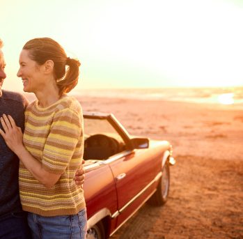 Man and Woman in the sunset with car in the background